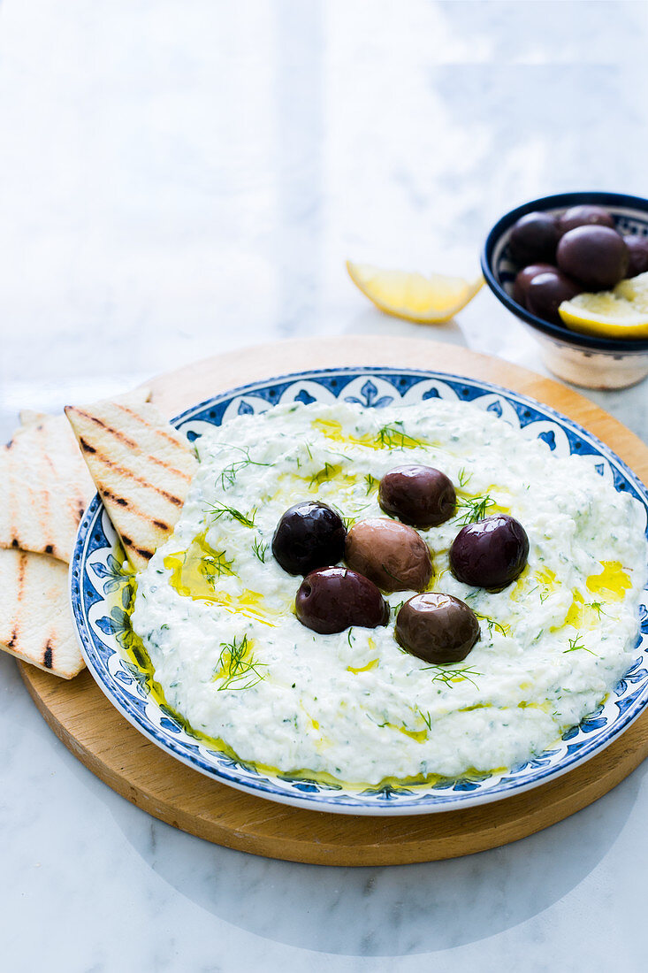 Tzatziki with olives and grilled bread