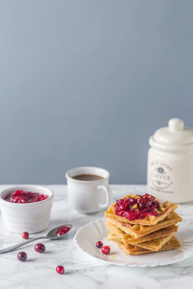 Waffles served with cranberry sauce and coffee