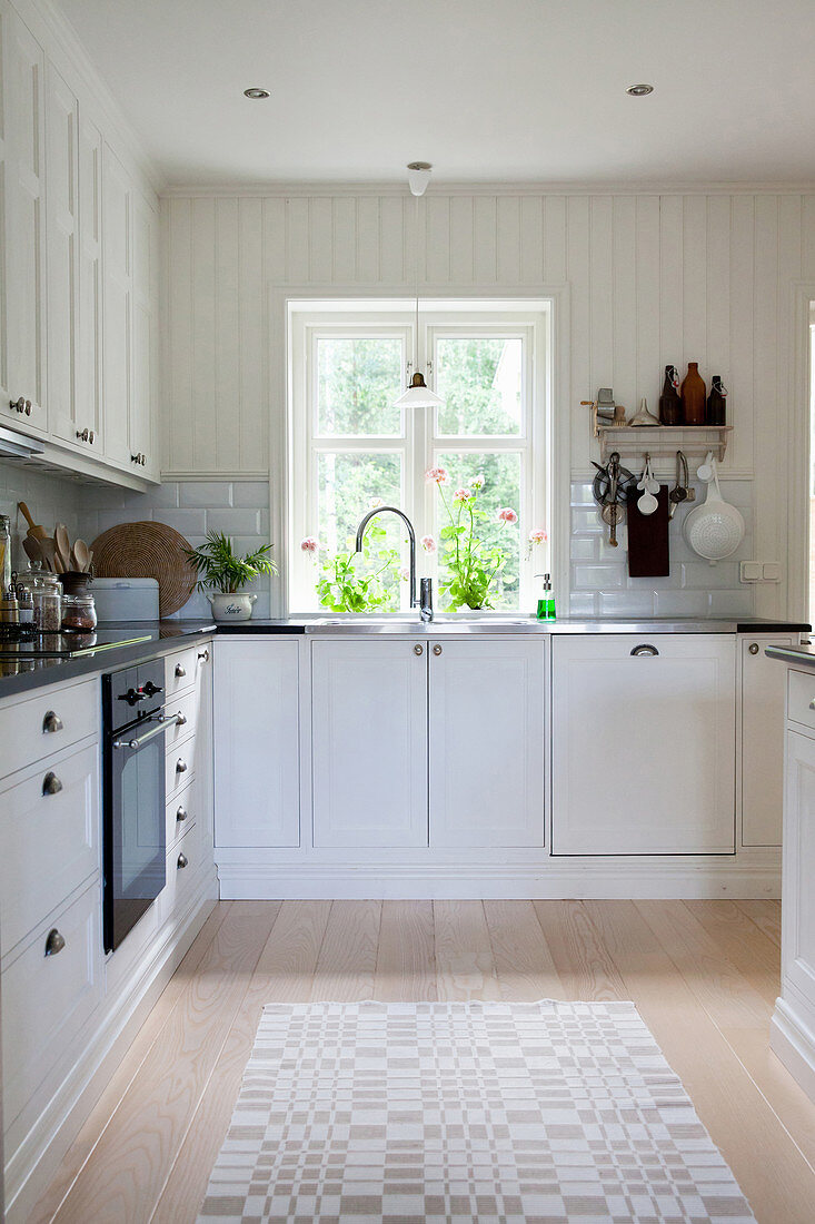White country-house kitchen with panelled walls
