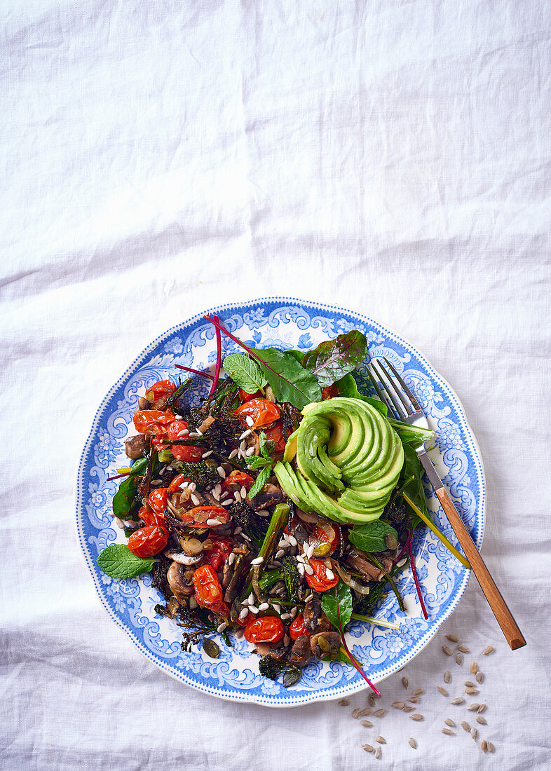 A superfood salad with avocado, cherry tomatoes and baby spinach