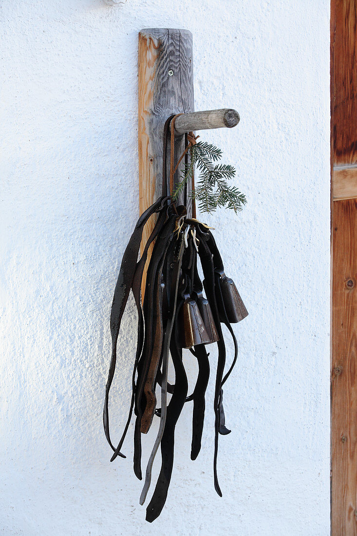 Sheep bells hanging on a wooden hook