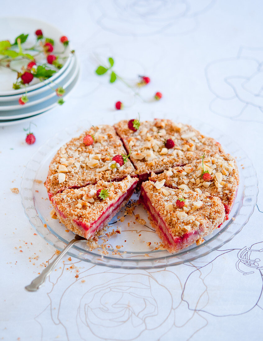 A strawberry cake with nut crumbles