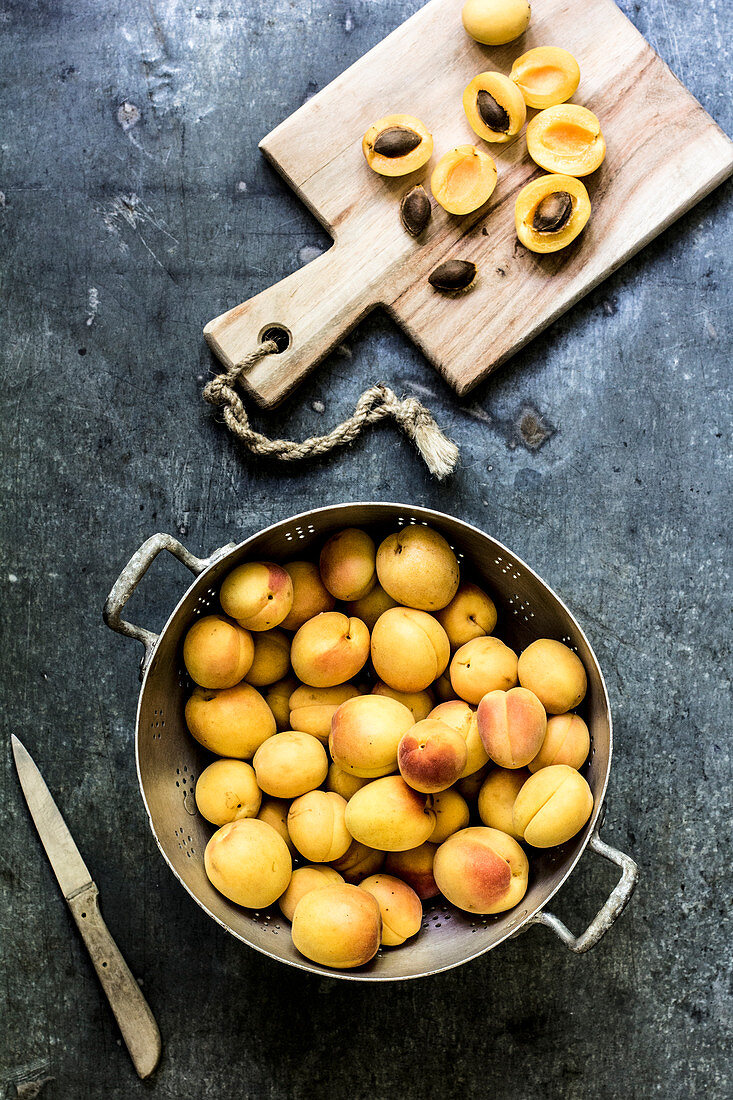 Apricots in a colander and on a chopping board