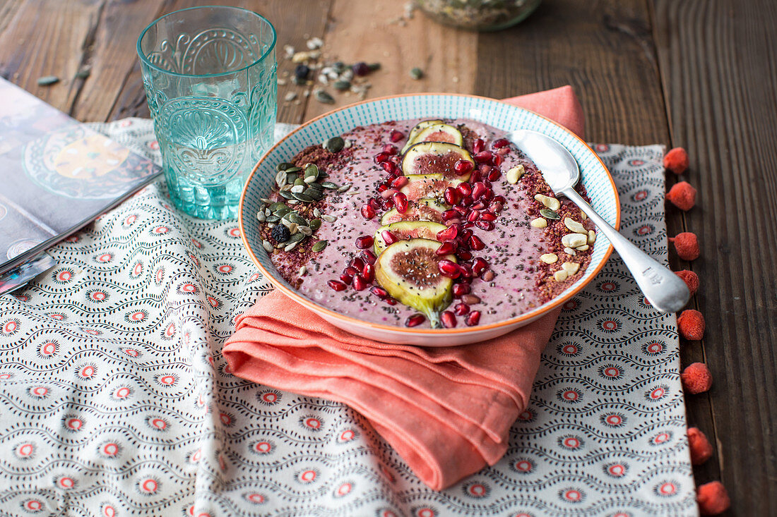 A smoothie bowl with pomegranate seeds