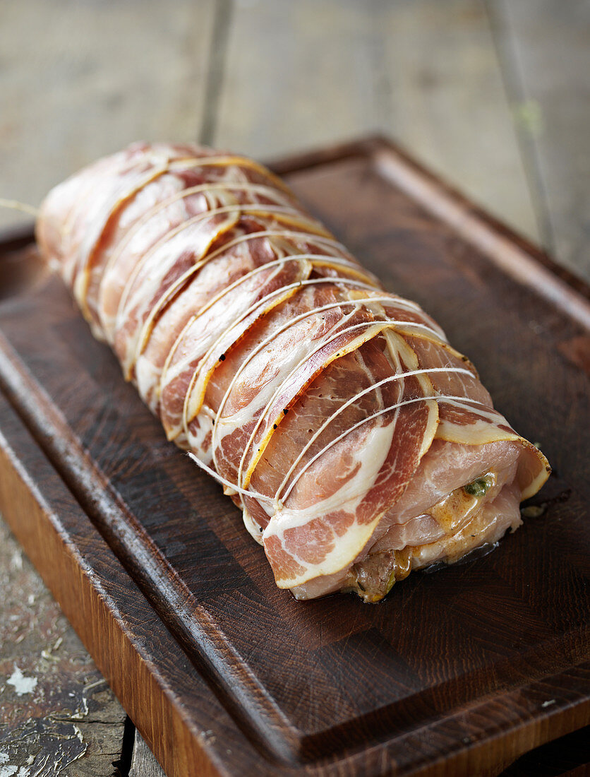 Raw pork wrapped in Parma ham