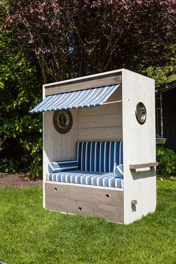 DIY wooden beach chair with blue-striped cushions