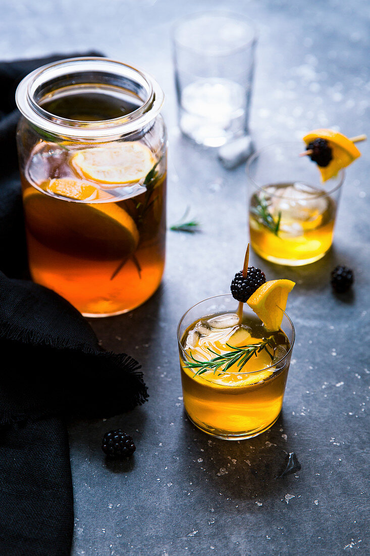Iced tea with oranges, blackberries and rosemary