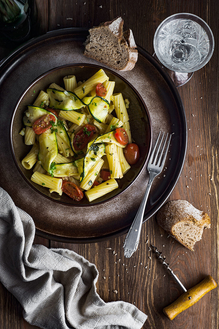 Rigatoni pasta with baked courgette, cherry tomatoes, thyme, onion and spices