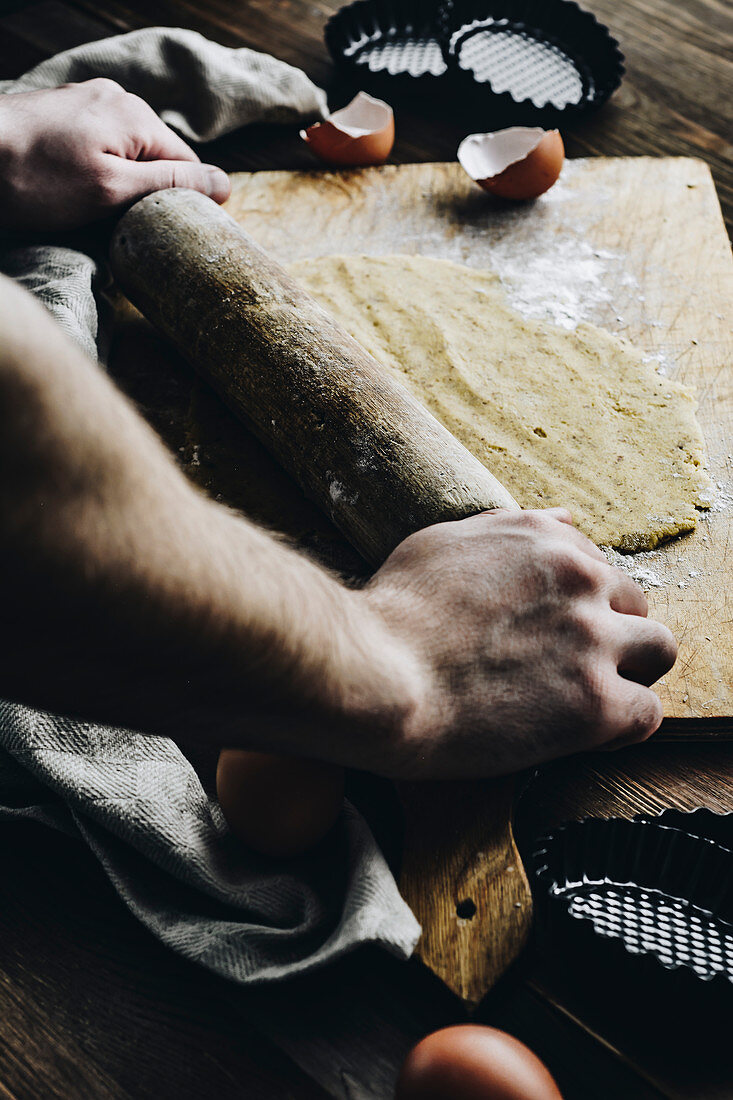 Rolling the dough on mini tarts