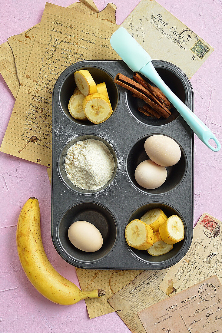 Ingredients for cinnamon and banana muffins in a muffin tin