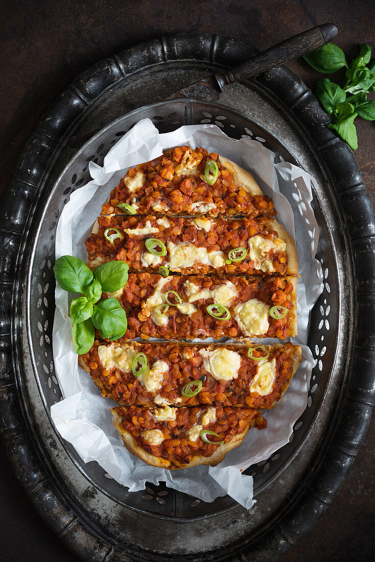 Vegan pizza with lentil bolognese and vegetable cheese (top view)