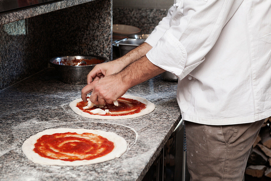 A chef making pizza