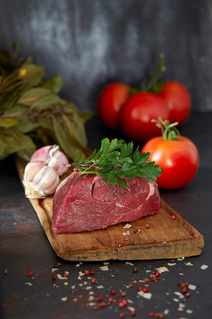 A raw beef fillet on a wooden board