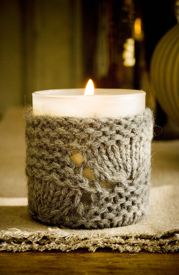 Votive candle lantern with knitted cover