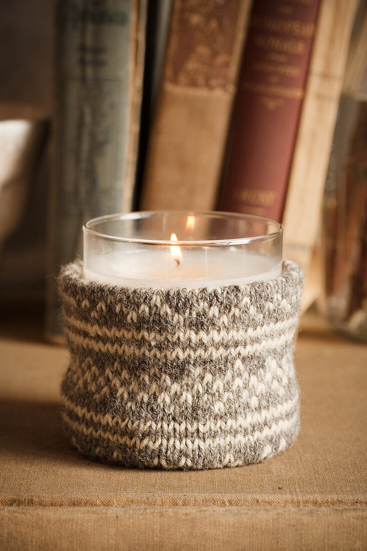 Votive candle lantern with knitted cover