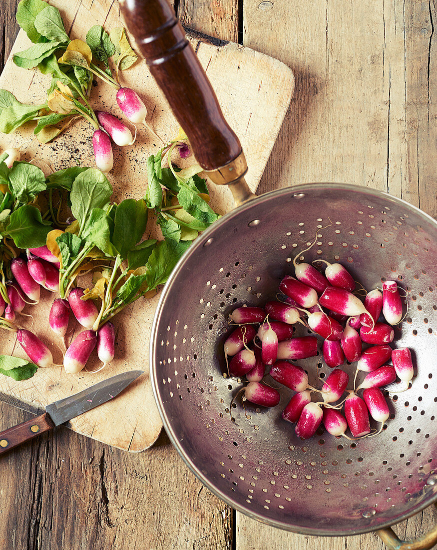 Washed and prepared radishes in a metal colander