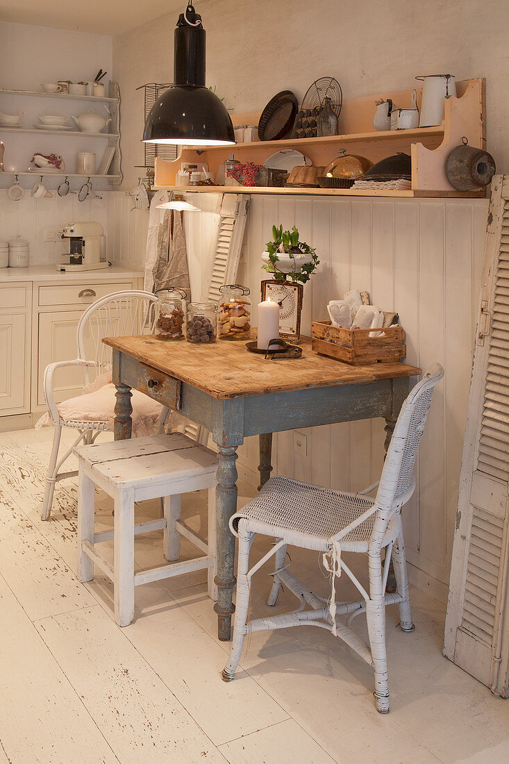 Shabby-chic dining area against white board wall