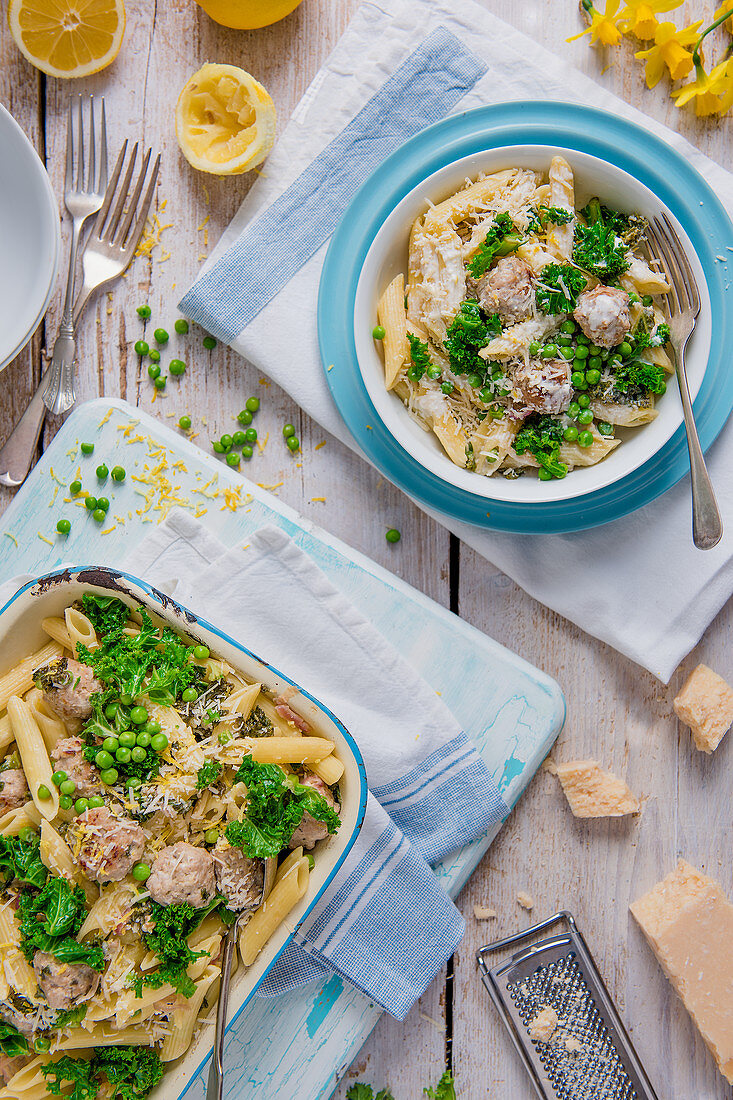 Penne pasta with sausage meatballs, peas, kale, creme fraiche and lemon sauce and parmesan cheese