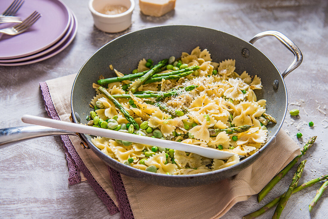 Spring pasta with cream sauce, peas, beans, asparagus and parmesan cheese