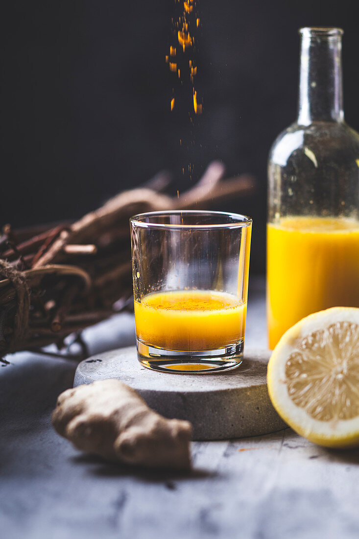 Detox and ginger shots with ginger juice, orange juice, lemon juice, turmeric and chilli