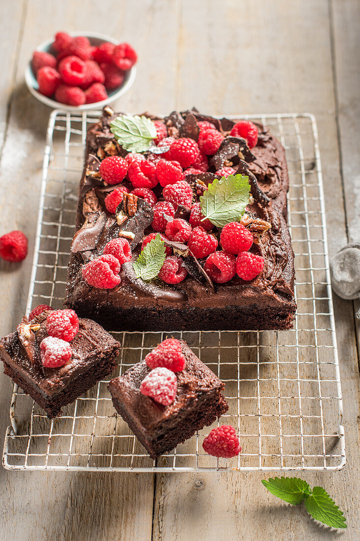 Chocolate tray bake with chocolate butercream icing and raspberries