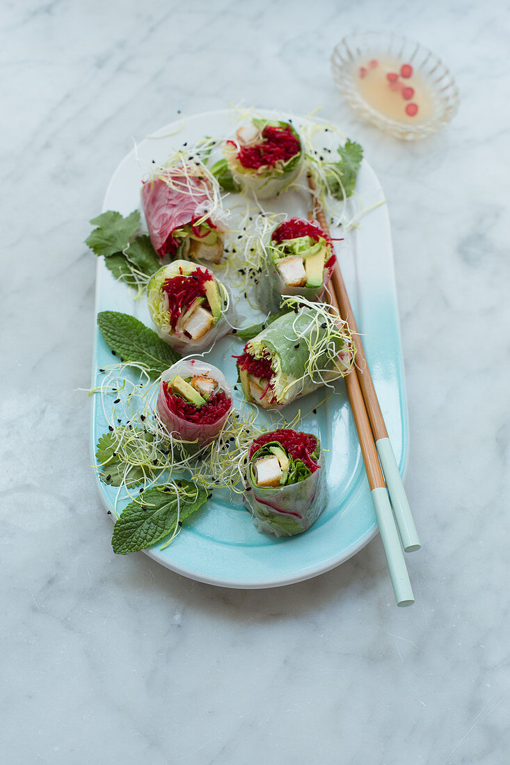 Rice paper rolls filled with chicken escalope, beetroot rice noodles, lettuce, avocado, coriander and mint