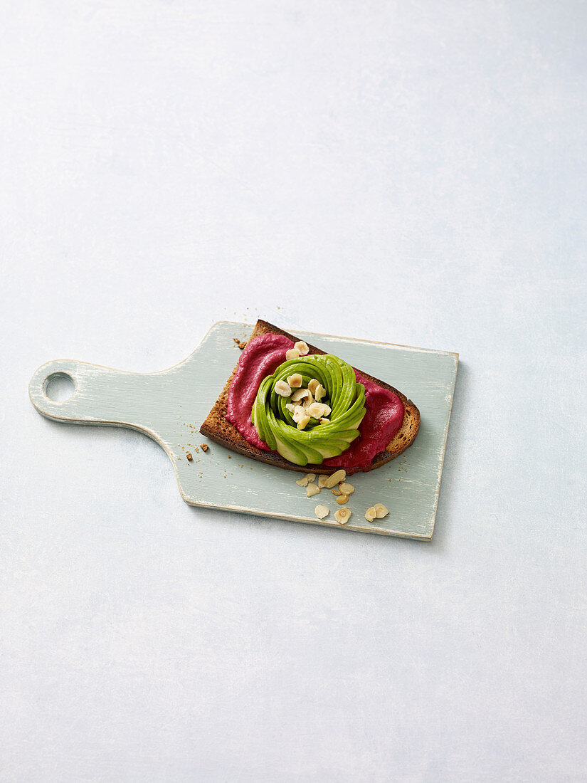 A rose-cut avocado with beetroot cream