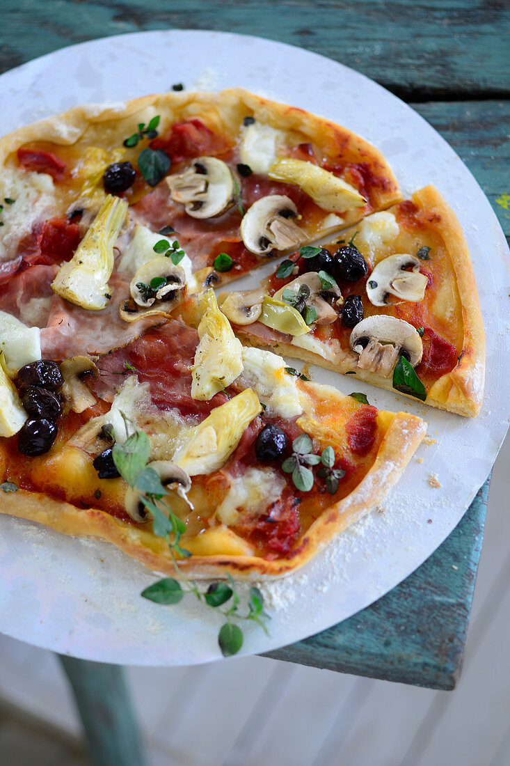 Pizza capricciosa (Pizza with ham, artichokes and olives, Italy)