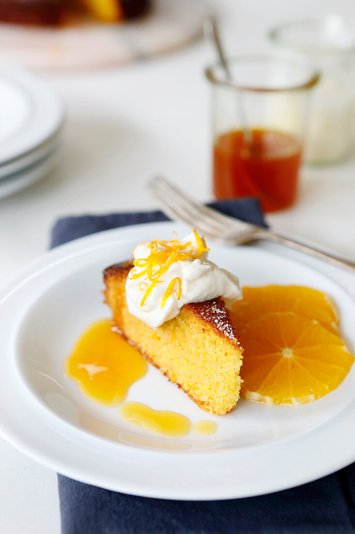 Orange Polenta Cake served with an orange, honey syrup and whipped cream