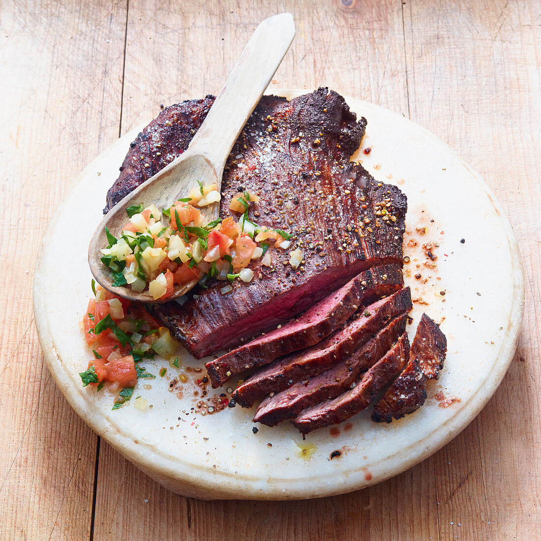 Grilled flank steak with parsley and tomato salsa
