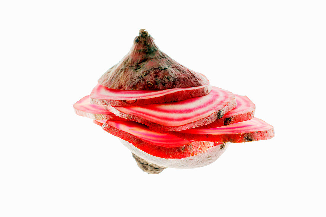 Sliced chioggia beets against a white background