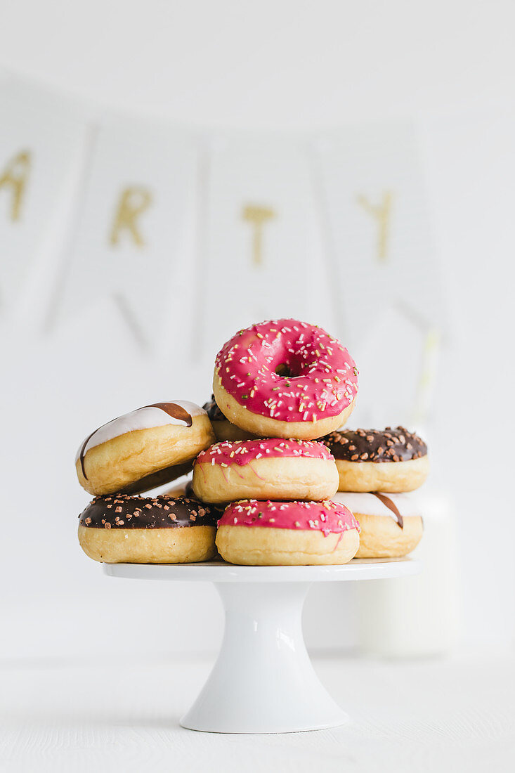 Donuts with different glazes on a cake stand