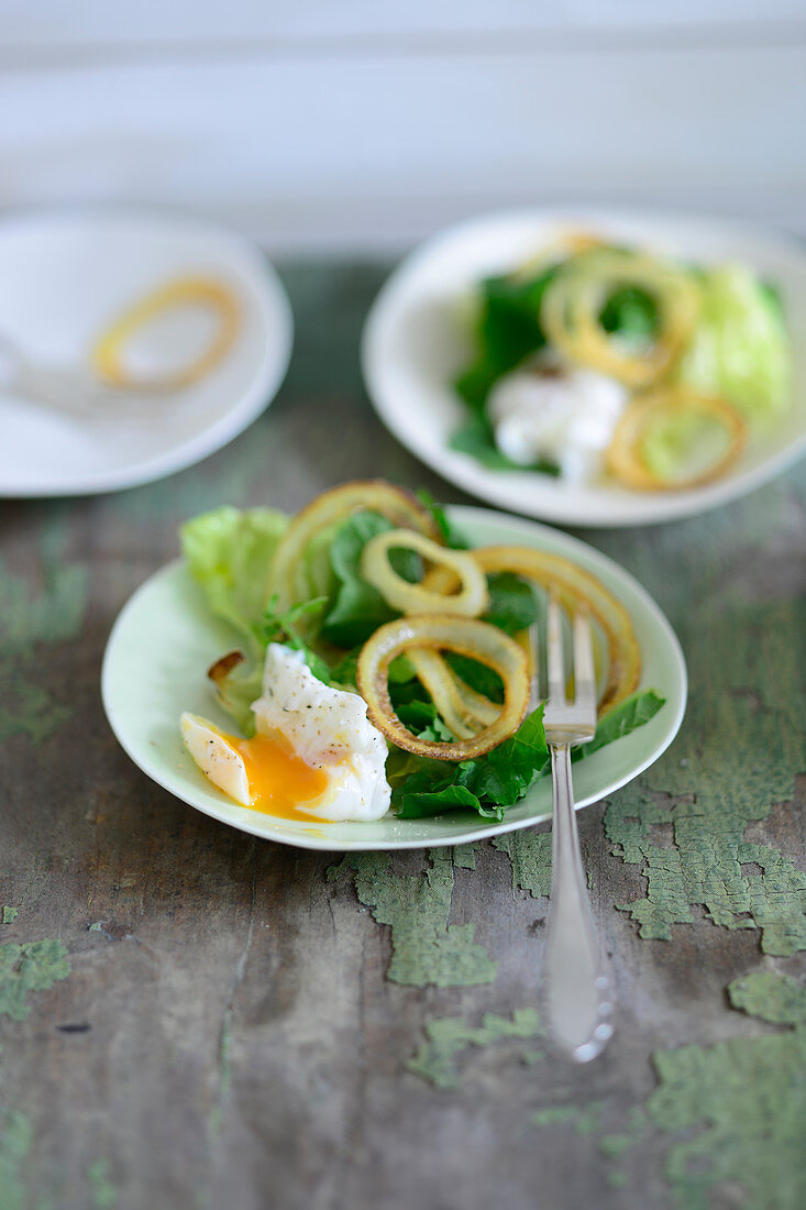 A salad with poached quail's eggs and roasted onions