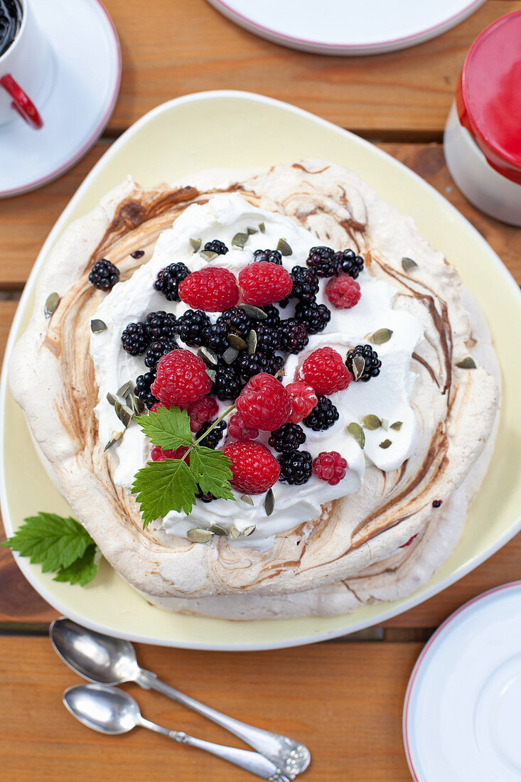 Pavlova with cream and fresh berries