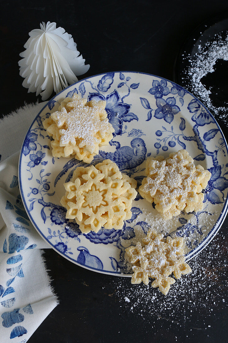 Gluten-free snowflake biscuits with icing sugar for Christmas
