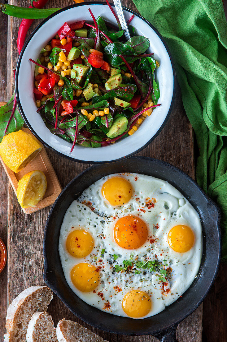 Spiegeleier und Salat mit Mais, Avocado und Paprika