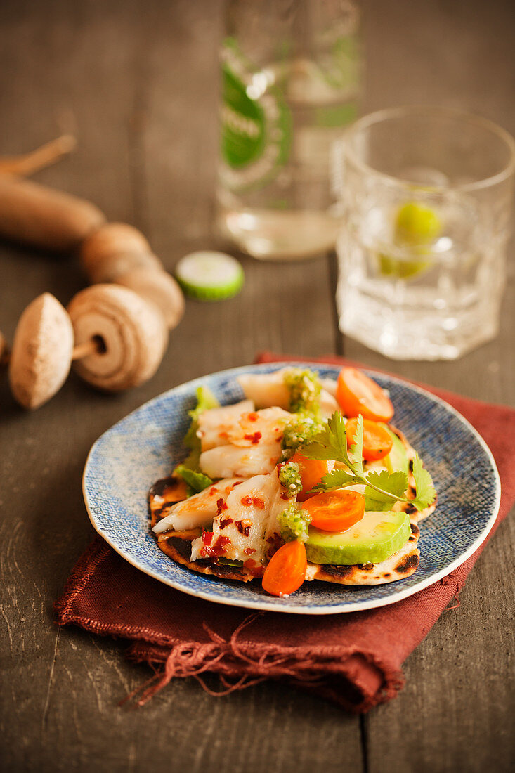 Tortilla with fish, avocado, cherry tomatoes and tomatillo salsa (Mexico)