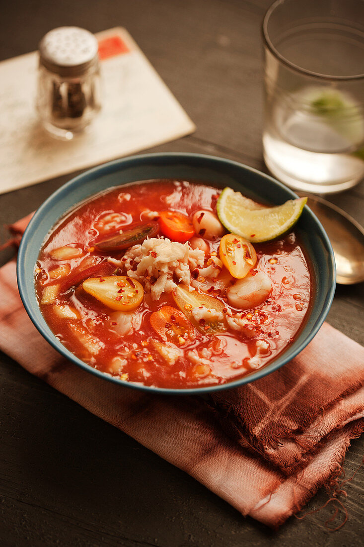 Mexican crab soup with tomatoes and limes