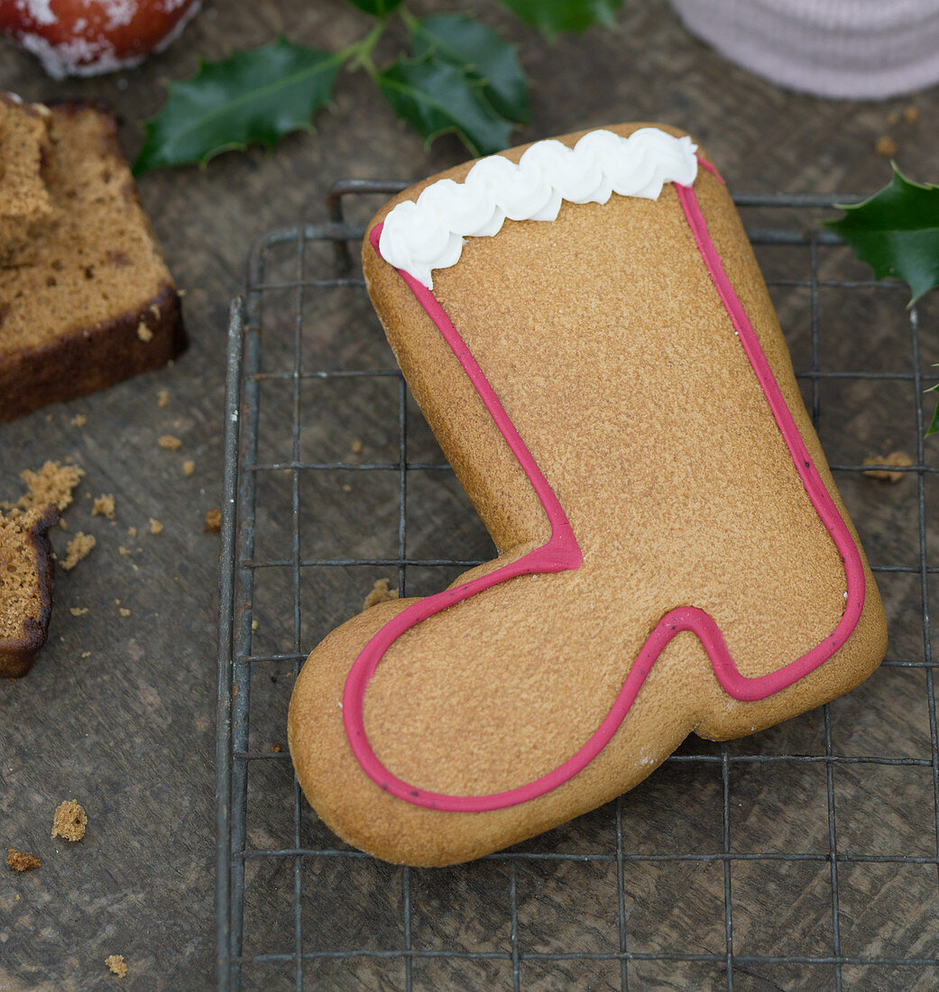 A gingerbread boot biscuit decorated with meringue