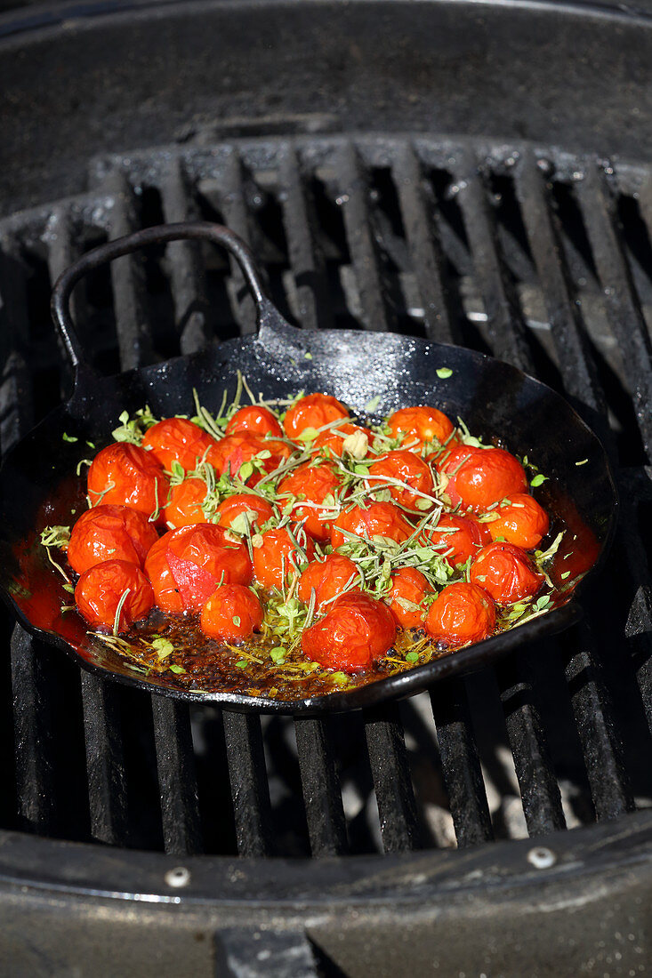 Grilled cherry tomatoes in an iron pan