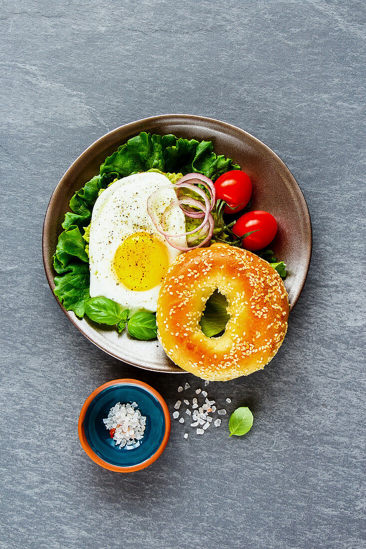 Vegetarisches Frühstück mit Bagel, Spiegelei und Gemüse (Aufsicht)