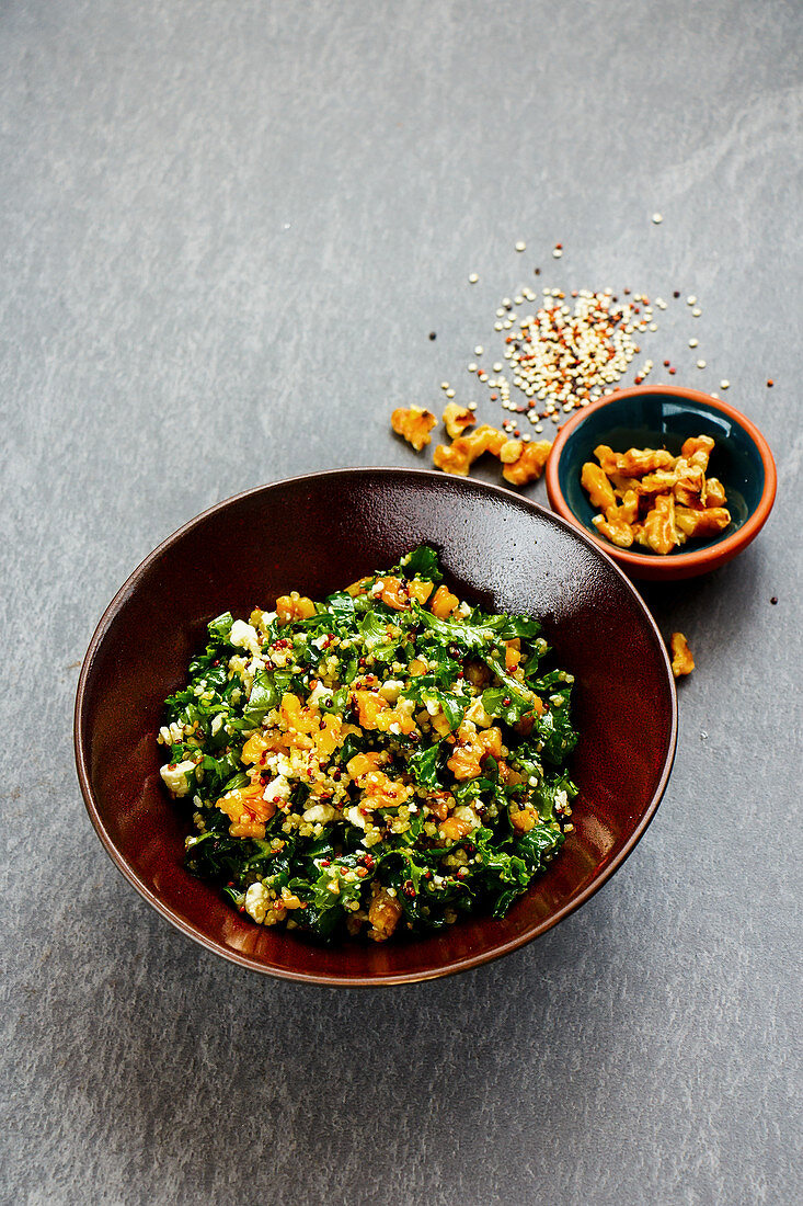 Kale salad with quinoa, feta cheese and walnuts