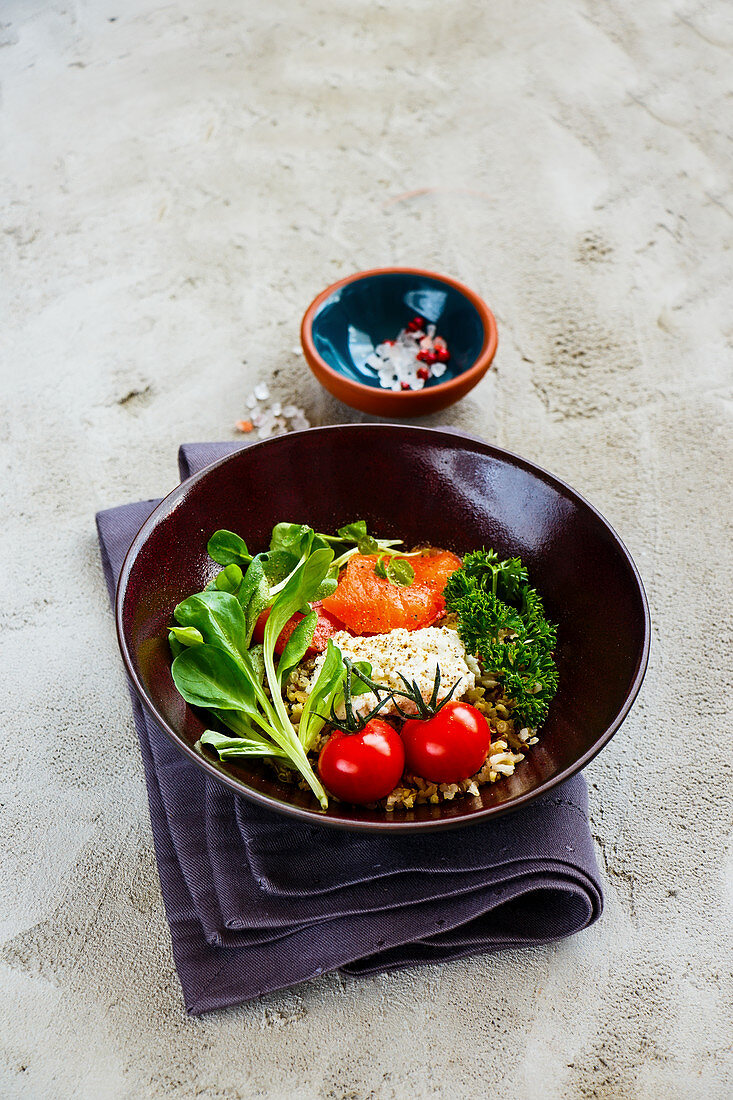 A rainbow Buddha bowl with quinoa, smoked salmon, ricotta and vegetables