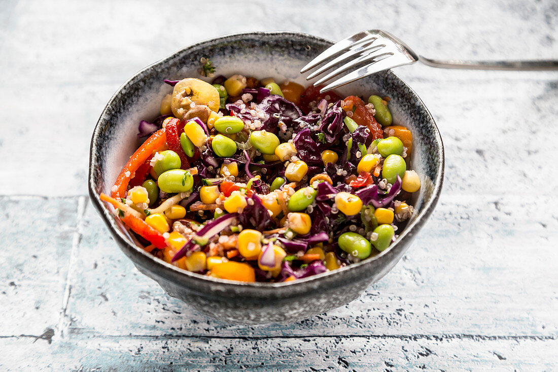 Colourful quinoa salad with tomatoes, sweetcorn, edamame, red cabbage, roasted chickpeas and carrots