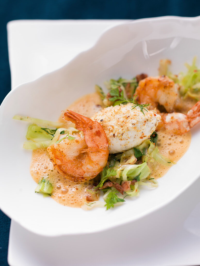 Shrimp with pike dumplings on white cabbage