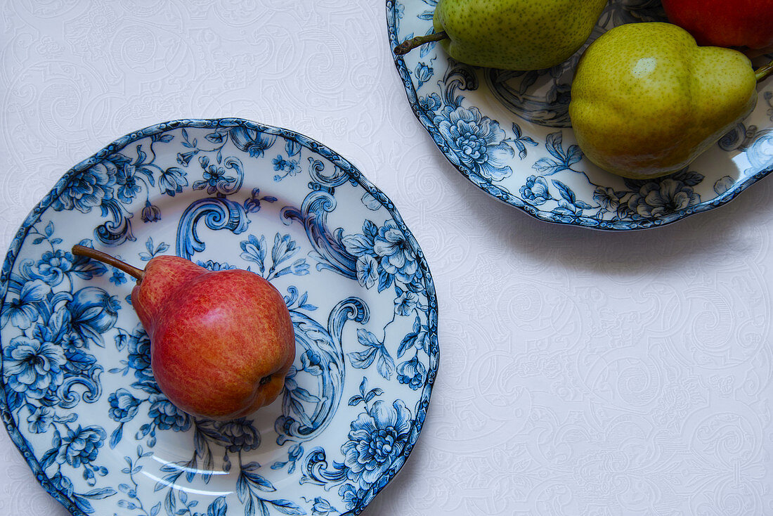 Red pear on a blue plate