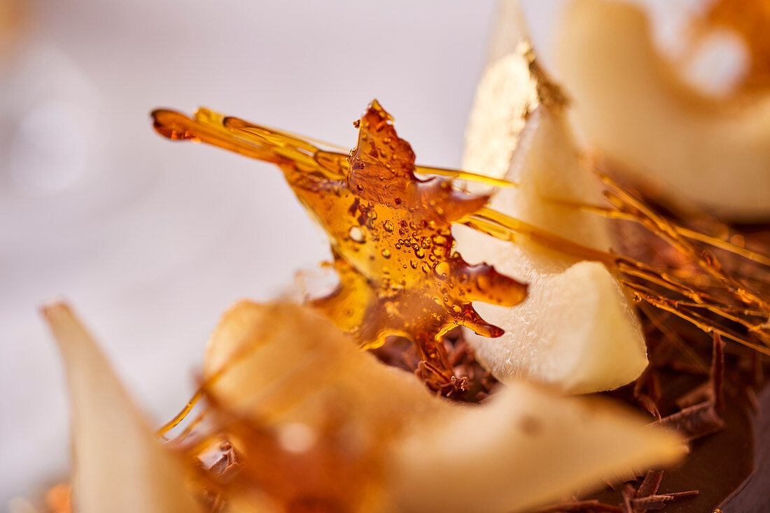 Pears and caramel on a yule log (close-up)