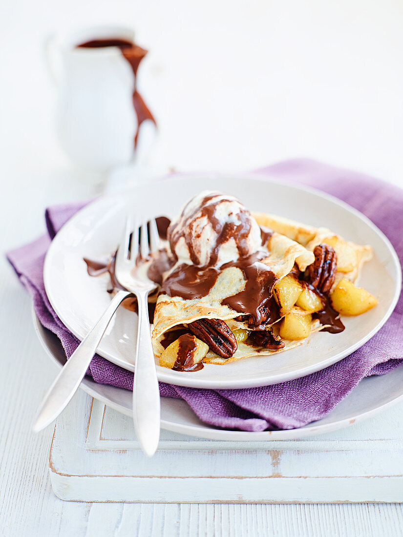 Crepes with chocolate sauce, pears and pecans