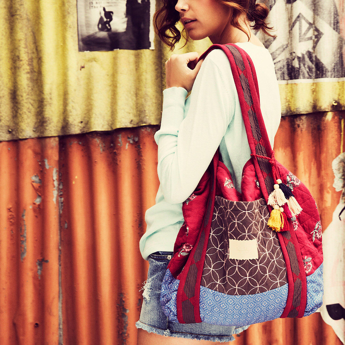 A young woman with a colourful bag