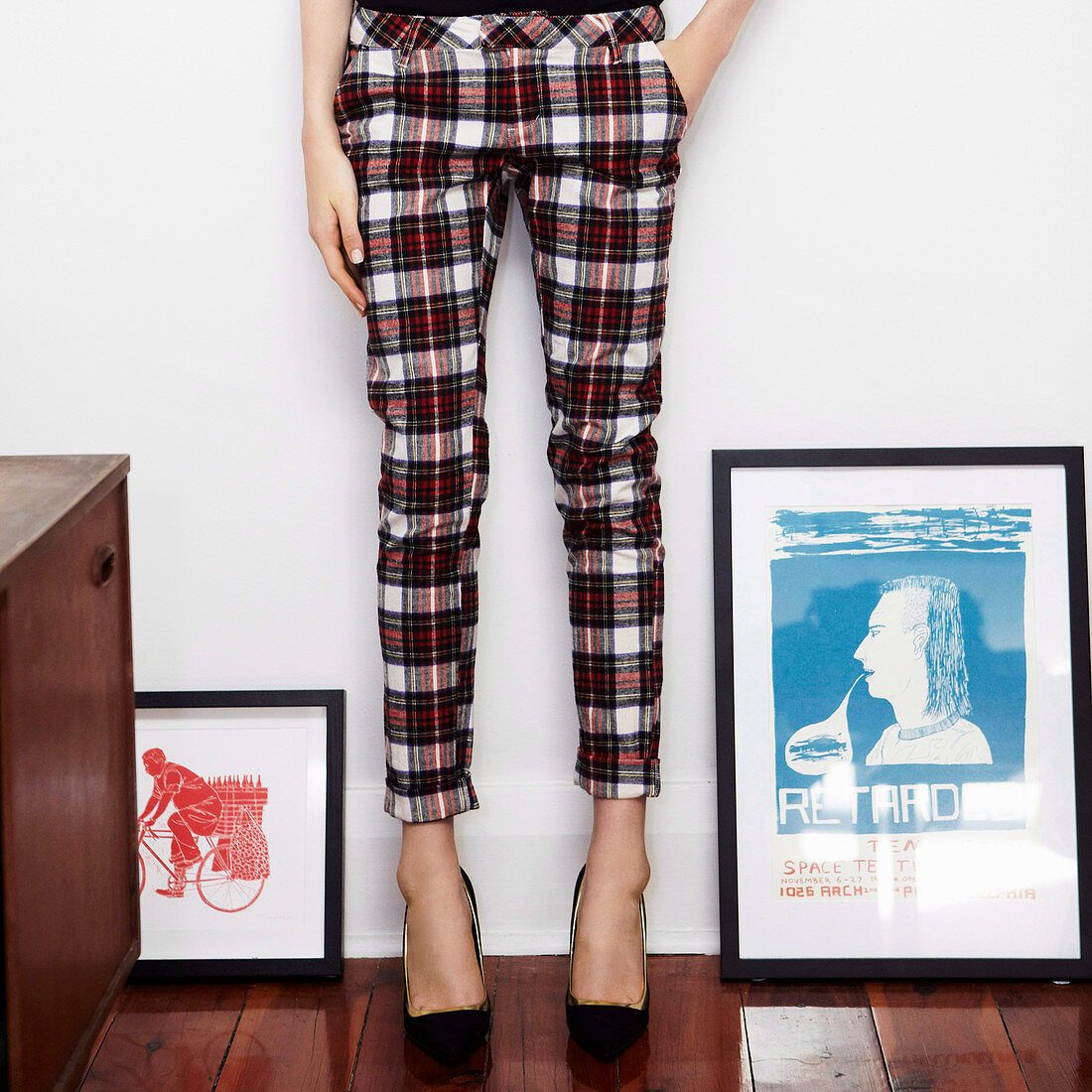A woman wearing checked trousers
